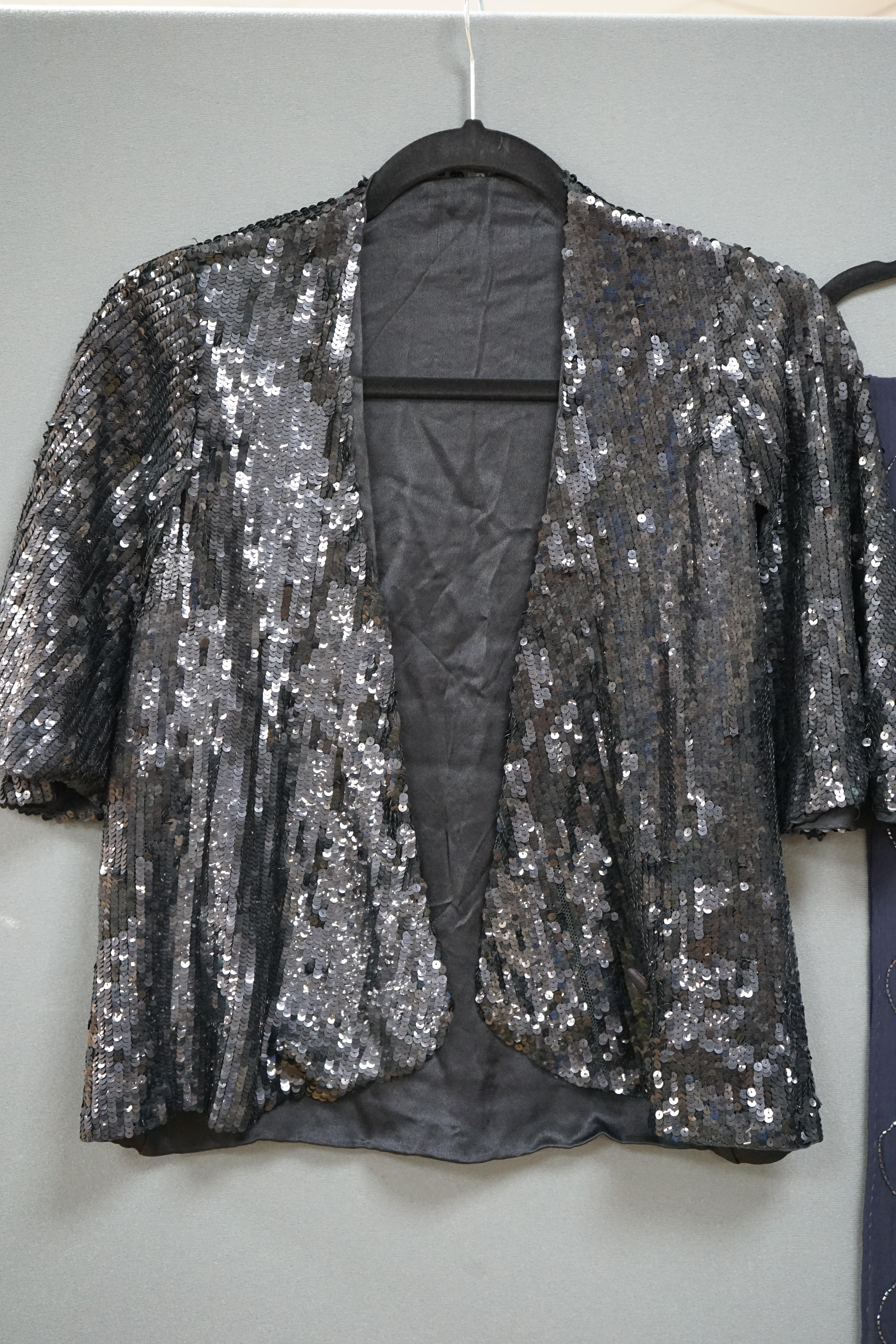 A late 1930’ early 40’s black sequin evening jacket and black chiffon beaded evening stole, the jacket designed with half cape sleeves and the stole, silk chiffon with wide beaded bordered ends and wavy beaded vertical s